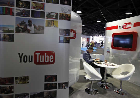 A visitor sits at the YouTube stand during the International Record Music Publishing and Video Music Market in Cannes.