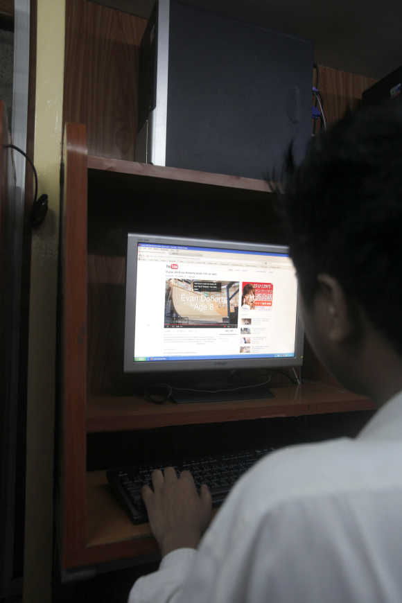 A man looks at online video portal YouTube at an internet cafe in Yangon, Myanmar.