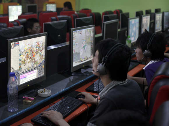 People play online games at an internet cafe in downtown Shanghai.
