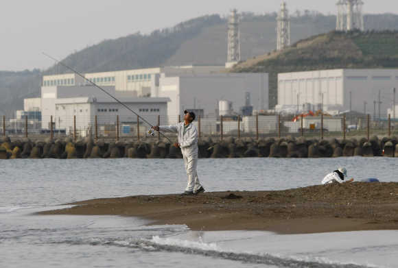 A man fishes near Tepco's Kashiwazaki-Kariwa nuclear plant in Kashiwazaki, Japan.