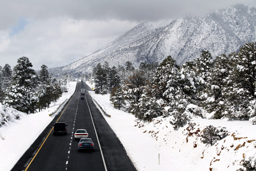 Motorists travel westbound along Interstate 40 after several inches of snow fell during a winter storm in Flagstaff, Arizona.