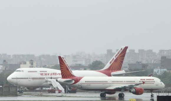 Air India aircraft on the tarmac during heavy rains at the Indira Gandhi International Airport in New Delhi.