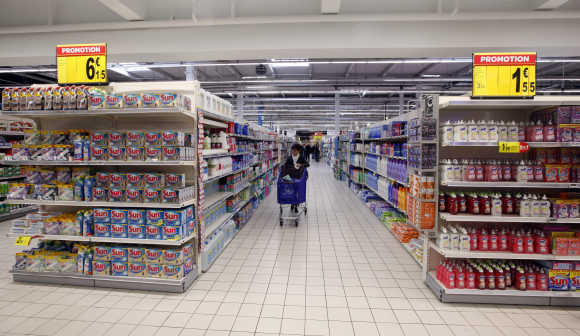 A customer shops in an aisle at Carrefour Planet supermarket in Nice, France.
