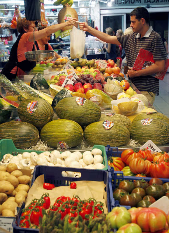 Man buys vegetables at El Masnou's local market near Barcelona.