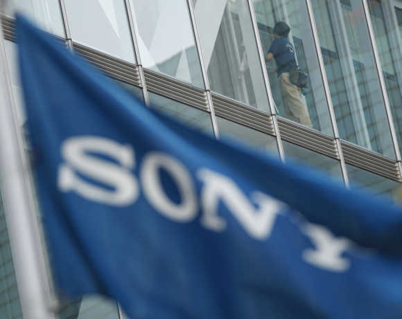 Sony Corp's headquarters is pictured past a flag bearing the company's logo in Tokyo.