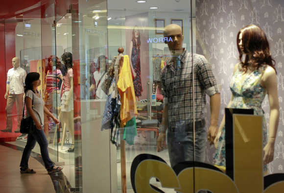 A woman enters a retail store inside a shopping mall in Mumbai.