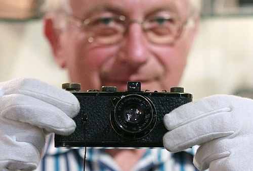 A former employee of a Leica shop Rupert Eder poses with a Leica 0 series camera in Westlicht gallery in Vienna.