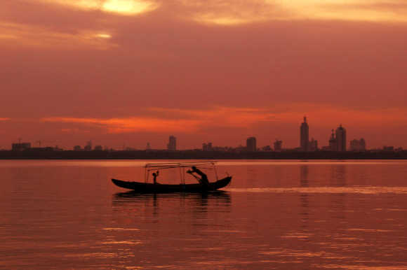 A boat plys the water of East Lake at sunset in the central Chinese city of Wuhan.