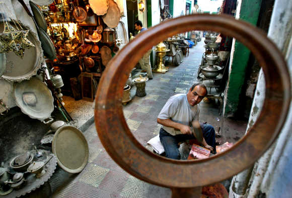 A man works at his shop in an old market of Tripoli, Libya.