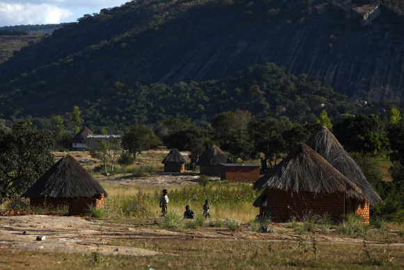 Children play outside thatched roof huts in Domboshawa, 80km east of Harare.