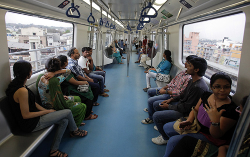 Commuters ride inside a carriage of a Namma Metro in Bangalore.