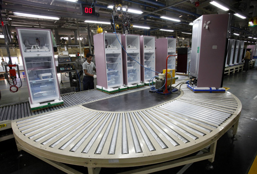 A worker at LG Electronics India Pvt Ltd. assembles refrigerators inside a factory at Greater Noida in Uttar Pradesh.