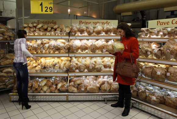 Women buy bread in a supermarket in Bucharest, Romania.
