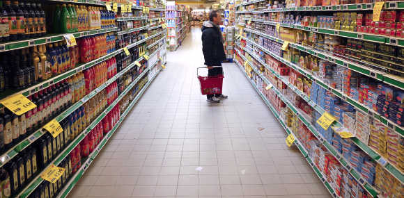 A man checks for prices in a supermarket in Rome.