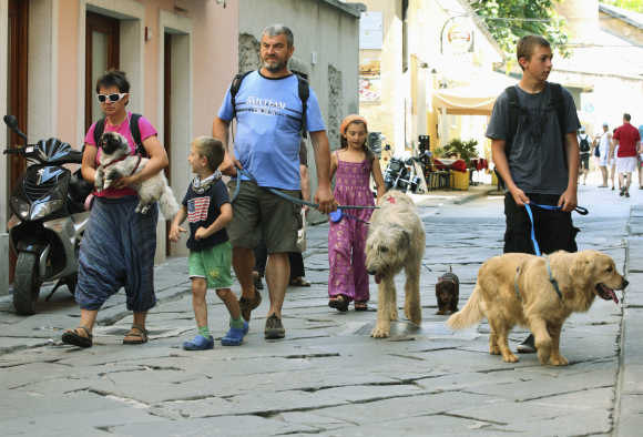 A family of Italian tourists walks their dogs in Croatia's northern Adriatic city of Pula, 270km south-west of Zagreb.