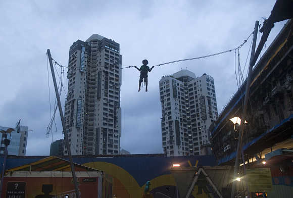 A boy plays on a giant trampoline in Mumbai.