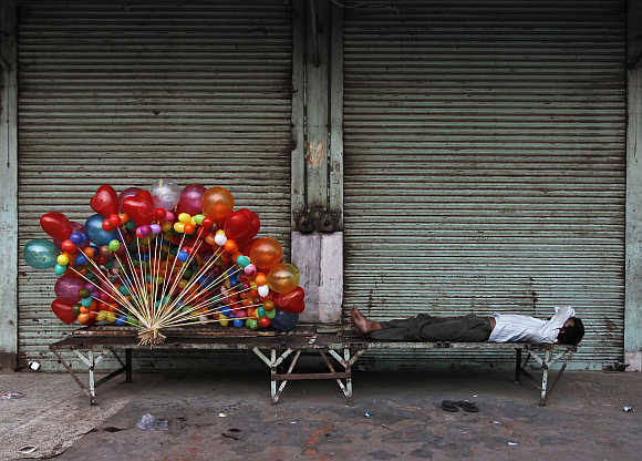A balloon seller takes a nap in Delhi.