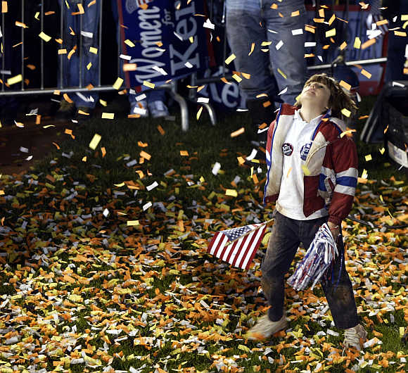 Eight-year-old Phoebe Moreo plays in the confetti spray in Dayton, Ohio.