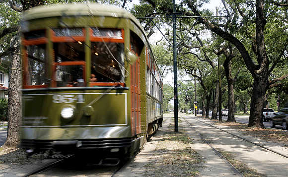 A Street Car travels down St Charles Avenue in New Orleans.