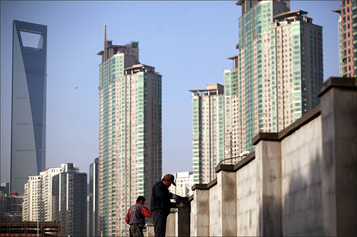 Workers build walls at a construction site at Pudong Lujiazui financial area in Shanghai.