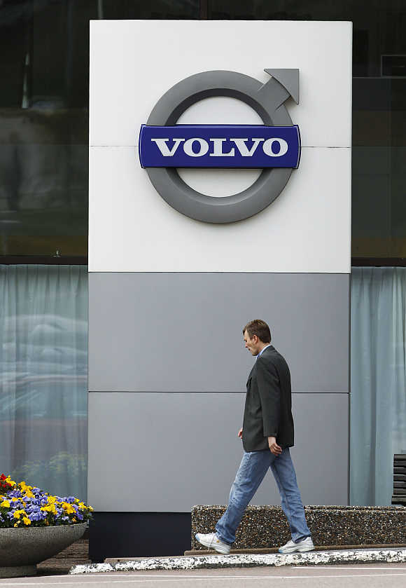 A man walks past the Volvo Car Corporation Headquarters in Gothenburg, Sweden.