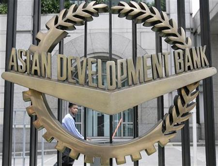 A worker walks past inside the Asian Development Bank (ADB) headquarters in Manila