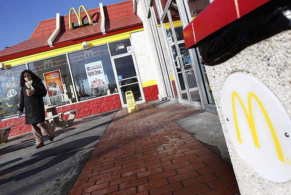 A woman walks out of a McDonald's restaurant in New York.