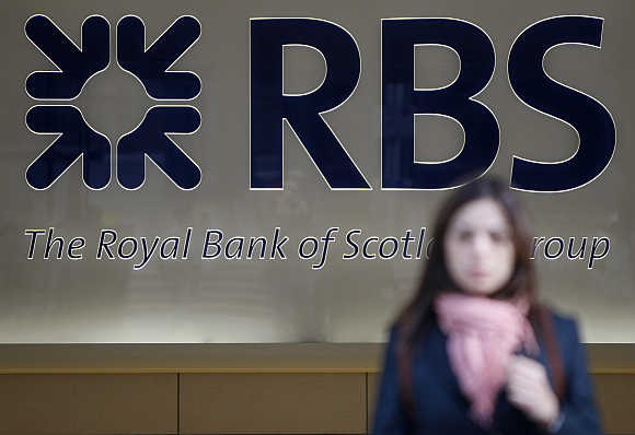 A woman leaves a Royal Bank of Scotland building in London.