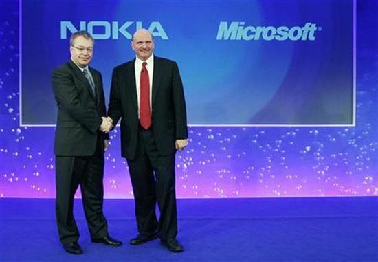 Nokia chief executive Stephen Elop (L) welcomes Microsoft chief executive Steve Ballmer with a handshake at a Nokia event in London
