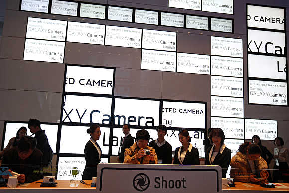 Visitors try out Samsung Electronics' Galaxy Camera in Seoul.
