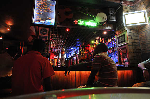 Patrons drink beer at a Maputo nightspot.