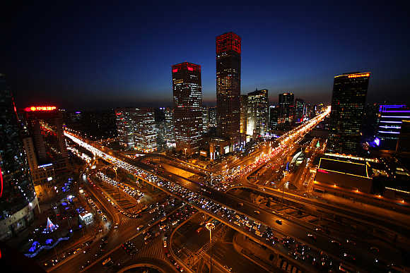 Vehicles drive on Three Ring Road and Jianwai Street in central Beijing.