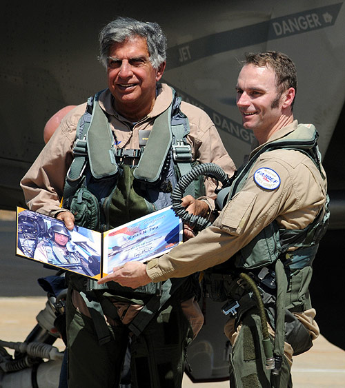 Ratan Tata receives a flight certificate from pilot Mike Wallace after they flew the F/A-18 Super Hornet aircraft during the 'Aero India 2011' at Yelahanka air force station in Bangalore.