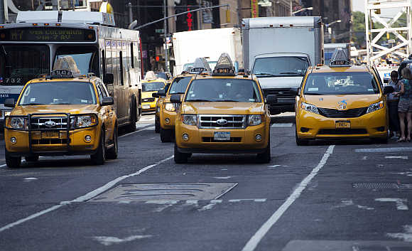 New York City taxis make their way through Times Square in New York.