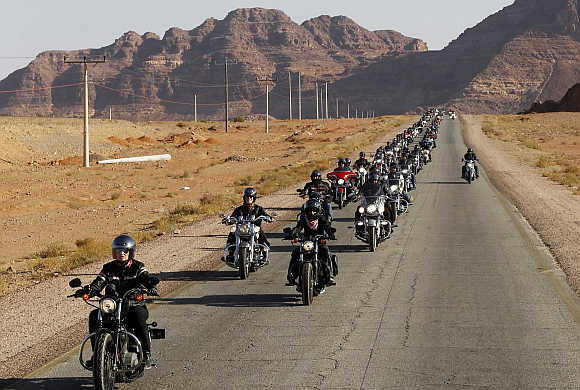 A convoy of 200 Harley-Davidson bikers ride through the desert in Wadi Rum in Jordan.