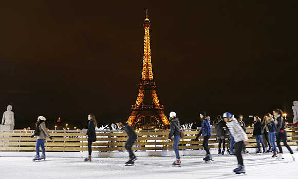 People skate on an artificial ice rink near the Eiffel Tower in Paris.