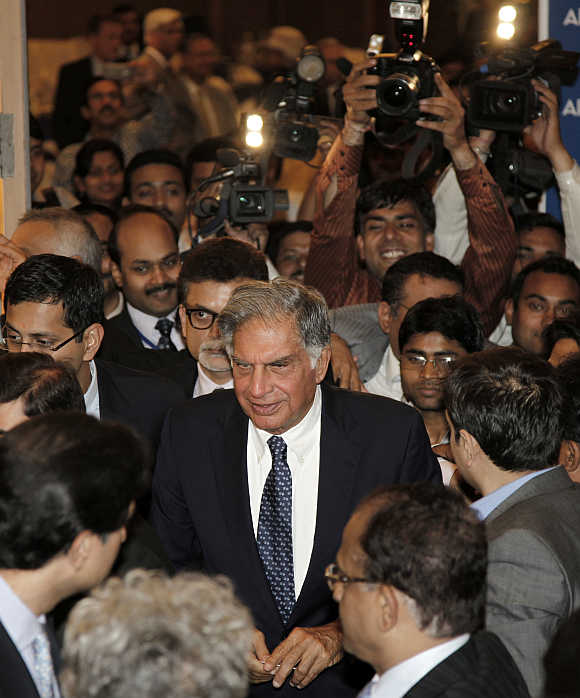 Ratan Tata, surrounded by the media, leaves the venue after receiving the life time achievement award for management conferred by the All India Management Association in New Delhi.