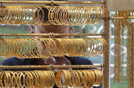 A man looks at gold jewellery in Amman, Jordan.