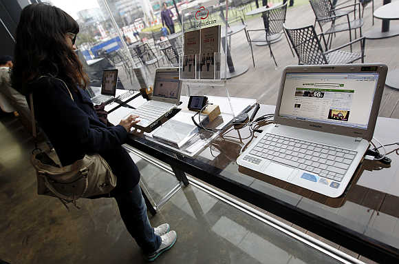 A woman surfs the Internet at South Korean mobile carrier KT's headquarters in Seoul.
