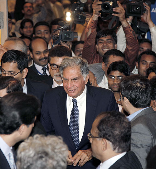 Ratan Tata (centre) leaves the venue after receiving the life time achievement award for management conferred by the All India Management
