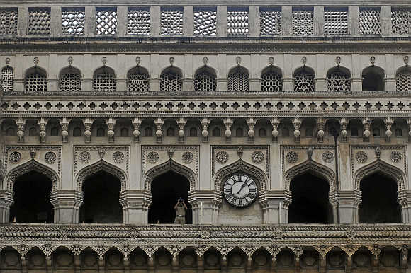A security personnel watches through binoculars from Charminar in Hyderabad.