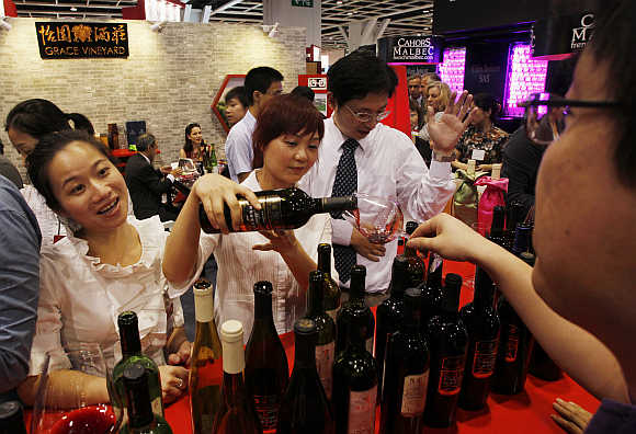 A Chinese wine producer from Shanxi province serves visitors in Hong Kong.