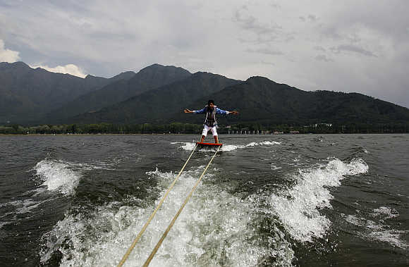 A tourist enjoys water skiing on the waters of Dal Lake in Srinagar.