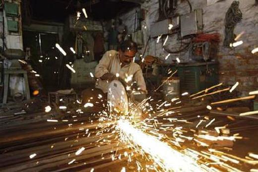 An employee works inside a metal workshop in Kolkata.