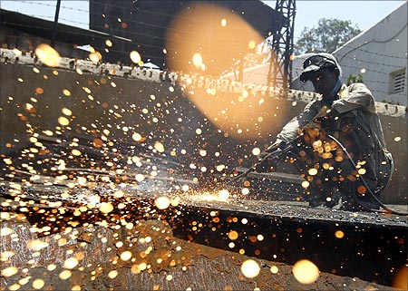 An employee works inside a steel rerolling mill at Chitra industrial area, on the outskirts of Bhavnagar town.