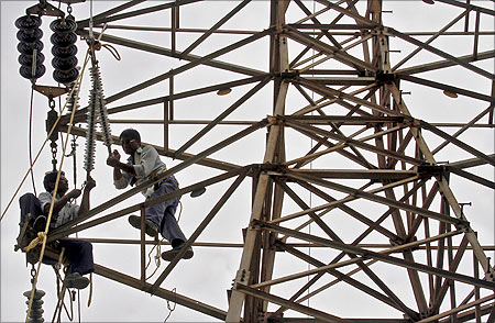 Employees of Gujarat Energy Transmission Corporation at work.