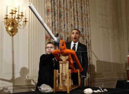 President Barack Obama reacts as Joey Hudy of Phoenix, Arizona, launches a marshmallow.