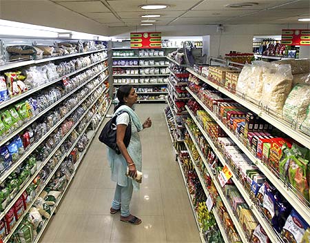 A customer looks at consumable goods before buying them at a supermarket in Hyderabad.