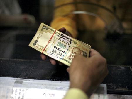 A man deposits his money in a bank in Amritsar.