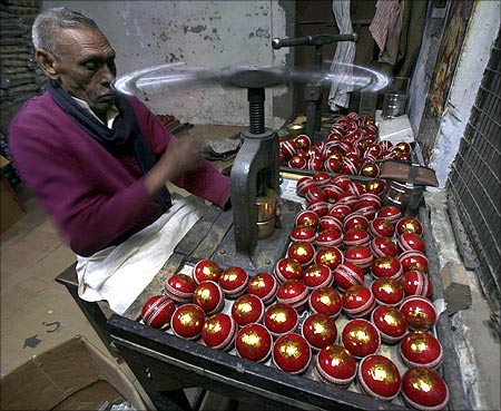  A worker stamps balls before they are packed at a factory in Meerut.